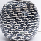 Close up of round table lamp with inlay fish pattern and linen shade on a white background from Addison West