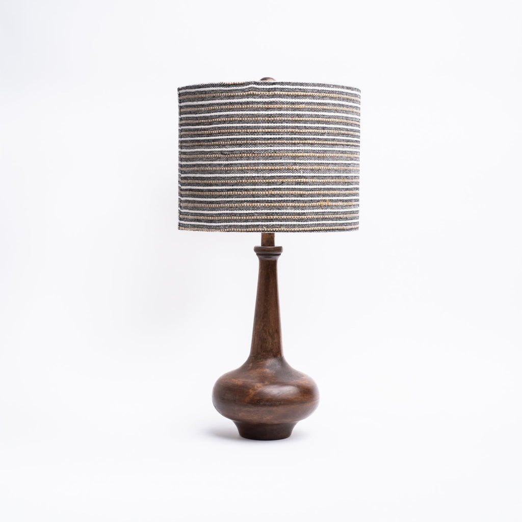 Dark wood curved lamp base with tall neck and striped linen shade on a white background