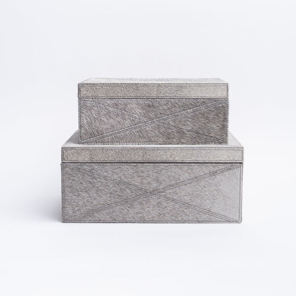 Two sizes of cowhide storage boxes stacked on a white background from Addison West home goods