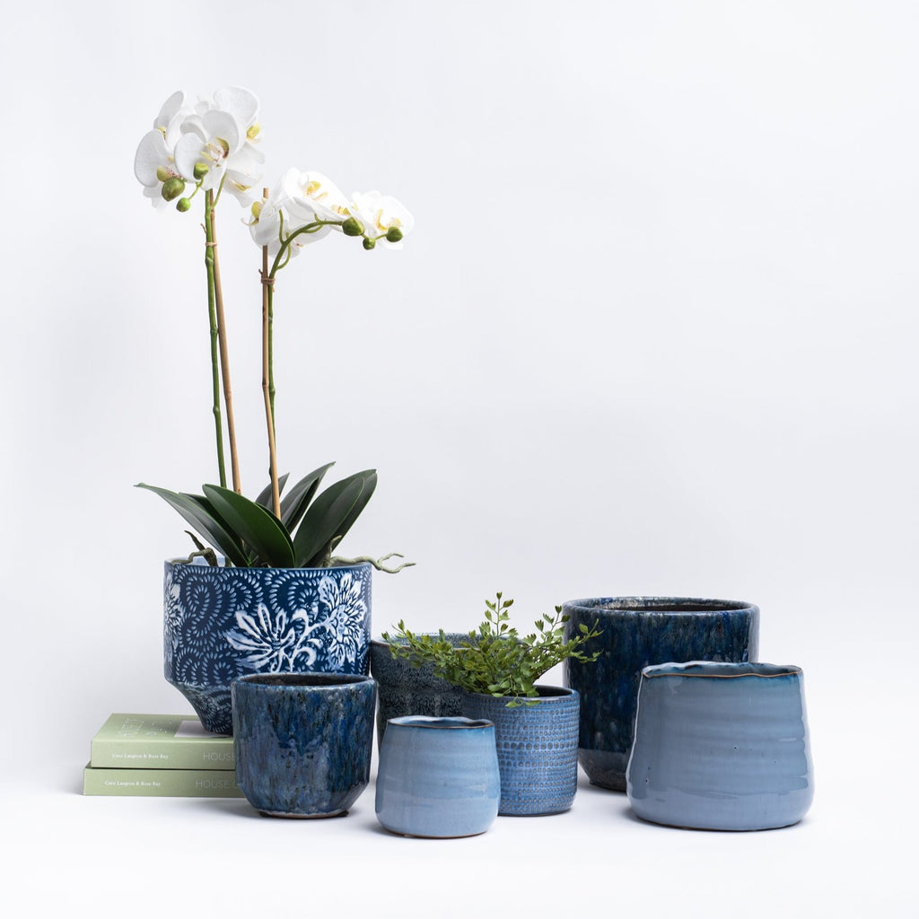 Grouping of blue pot planters on a white background from Addison West home goods