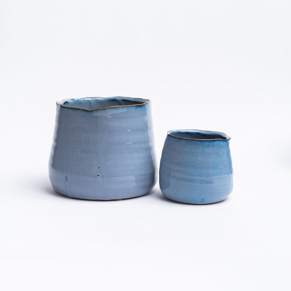 Set of two large and small blue pots on a white background