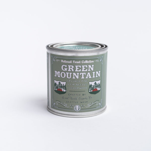 green mountain candle in a tin on a white background