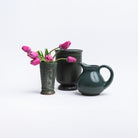 Collection of forest green stoneware pot vase and pitcher on a white background