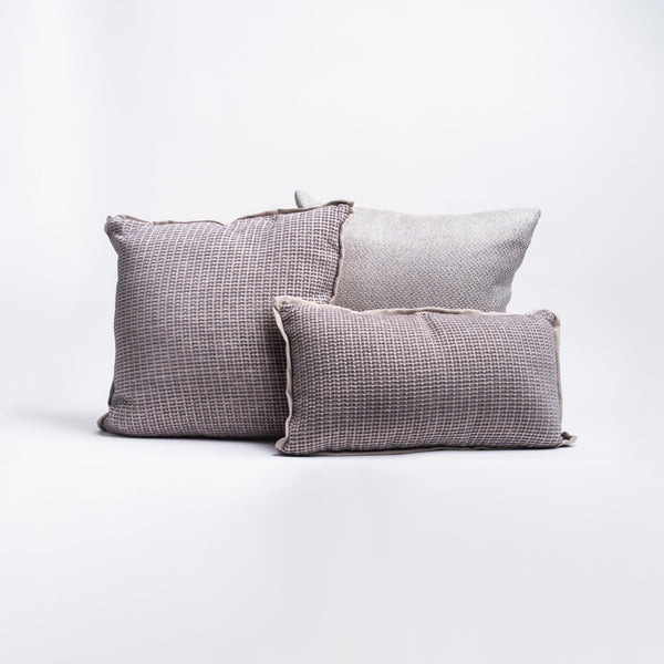 20" Square Sasha outdoor Throw Pillow In Taupe with other outdoor pillows on a white background