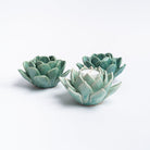 Blue succulent tea light holders on a white background