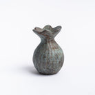 Small round cast iron vase with patina green finish and fluted top on a white background