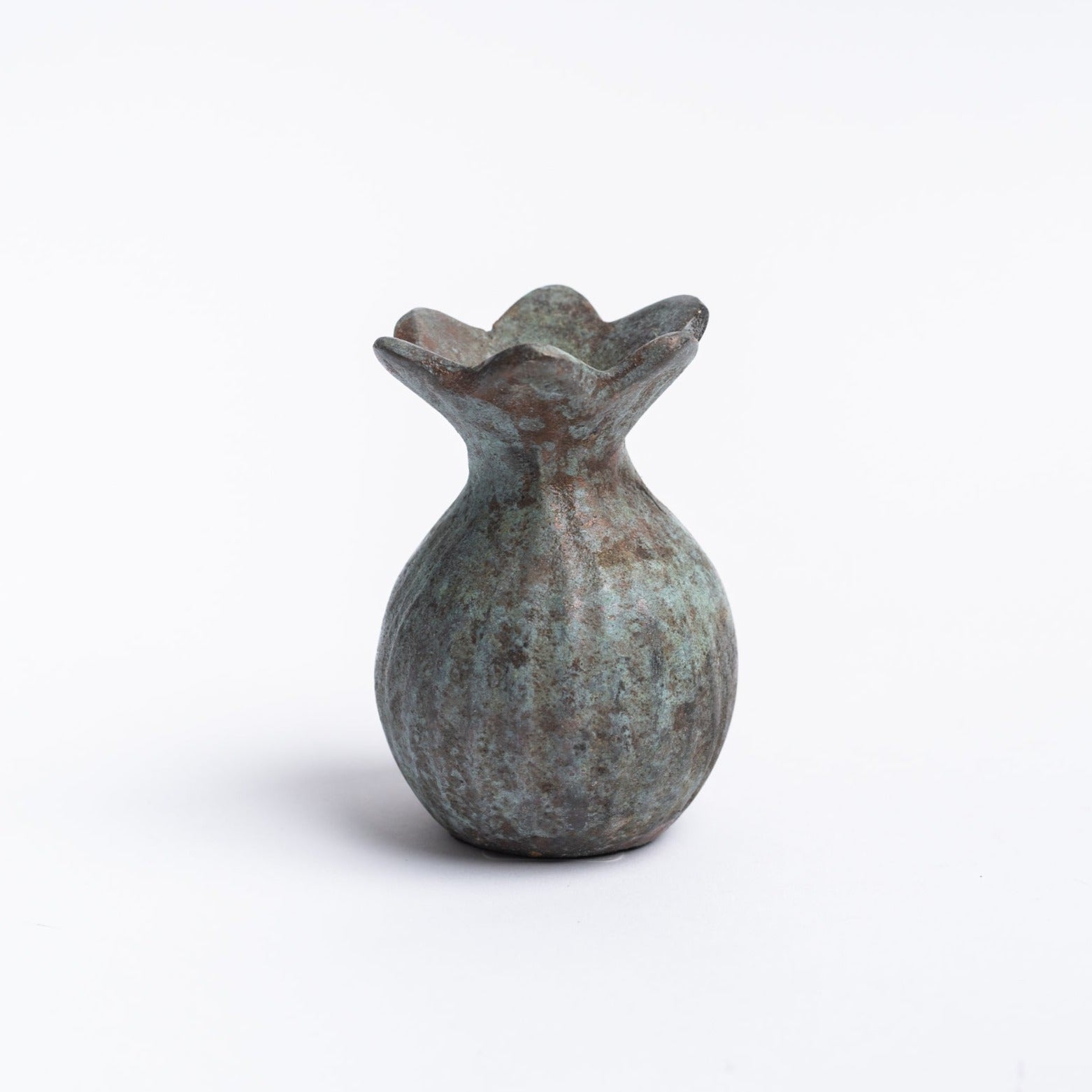 Small round cast iron vase with patina green finish and fluted top on a white background