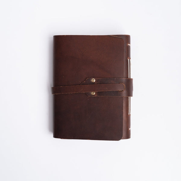 Vermont leather handmade journal with strap on a white background