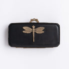 Small black dragonfly box with gold accents on a white background
