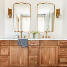 Palecek Bronson Sconce In Brass in a bathroom at Addison West
