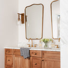 Palecek Bronson Sconce In Brass in a bathroom at Addison West