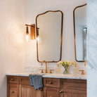 Palecek Bronson Sconce In Brass in a bathroom at Addison West