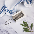 Marble and Stainless Steel Grater on a marble kitchen counter at Addison West