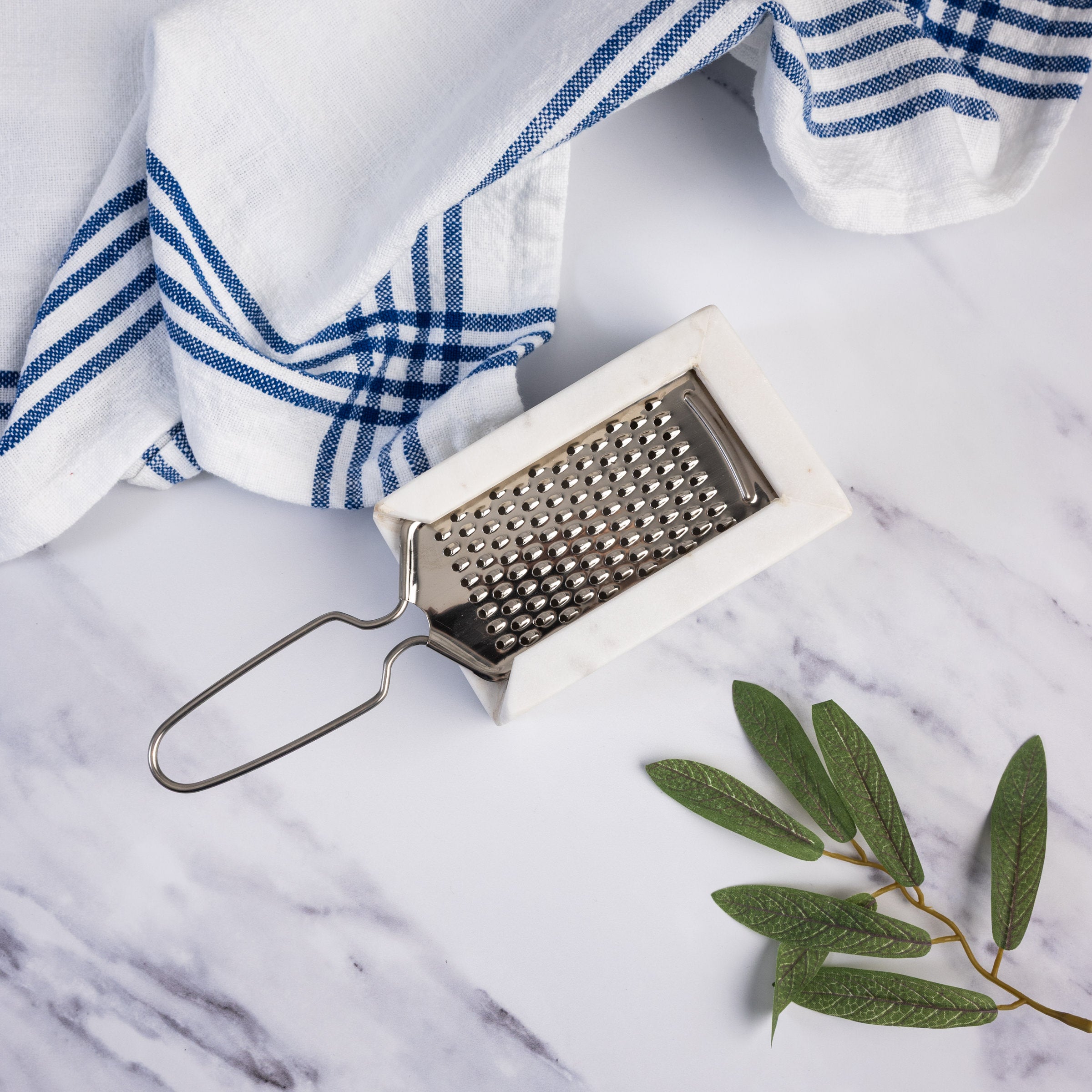 Marble and Stainless Steel Grater on a marble kitchen counter at Addison West