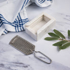 Marble and Stainless Steel Grater on a marble kitchen counter at Addison West