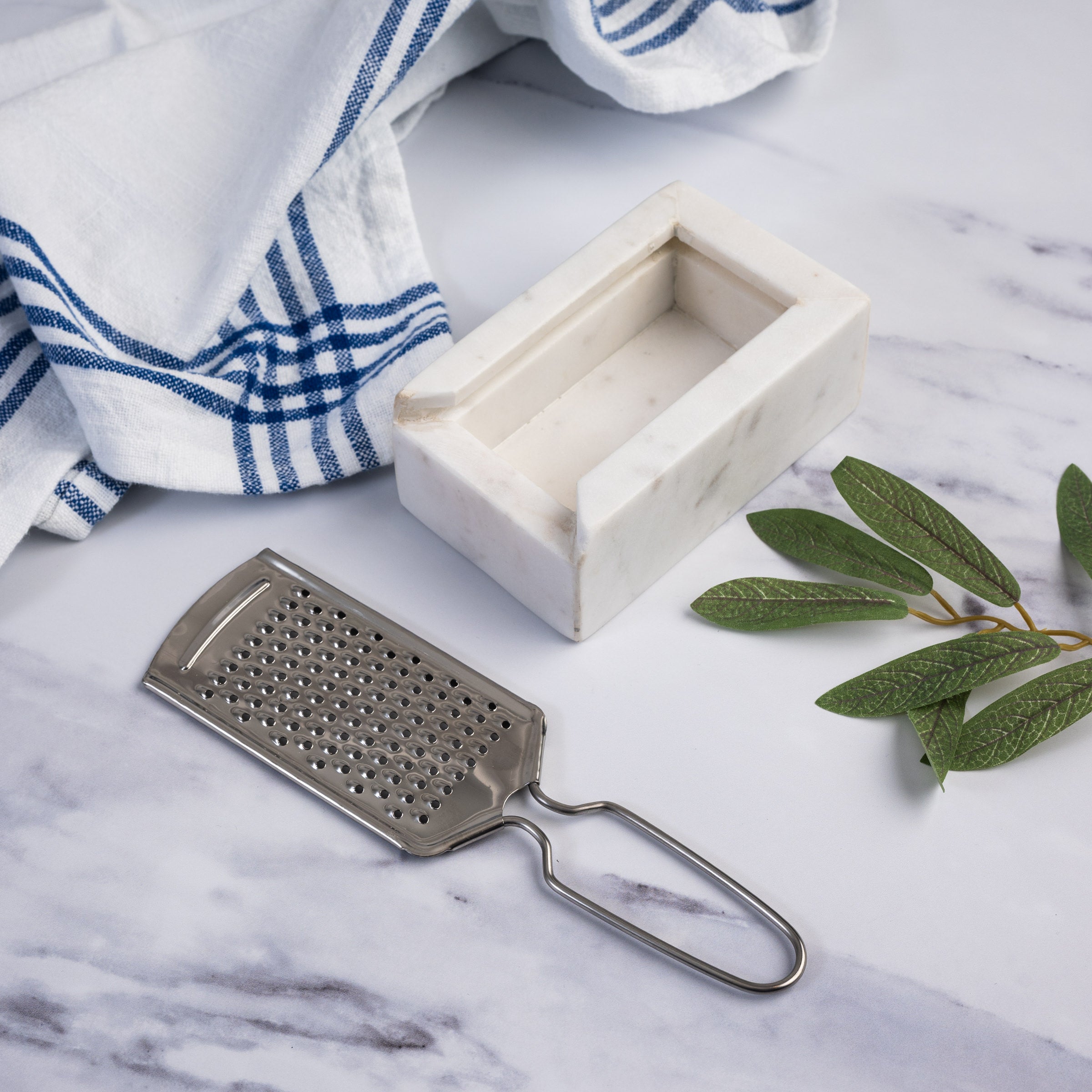 Marble and Stainless Steel Grater on a marble kitchen counter at Addison West