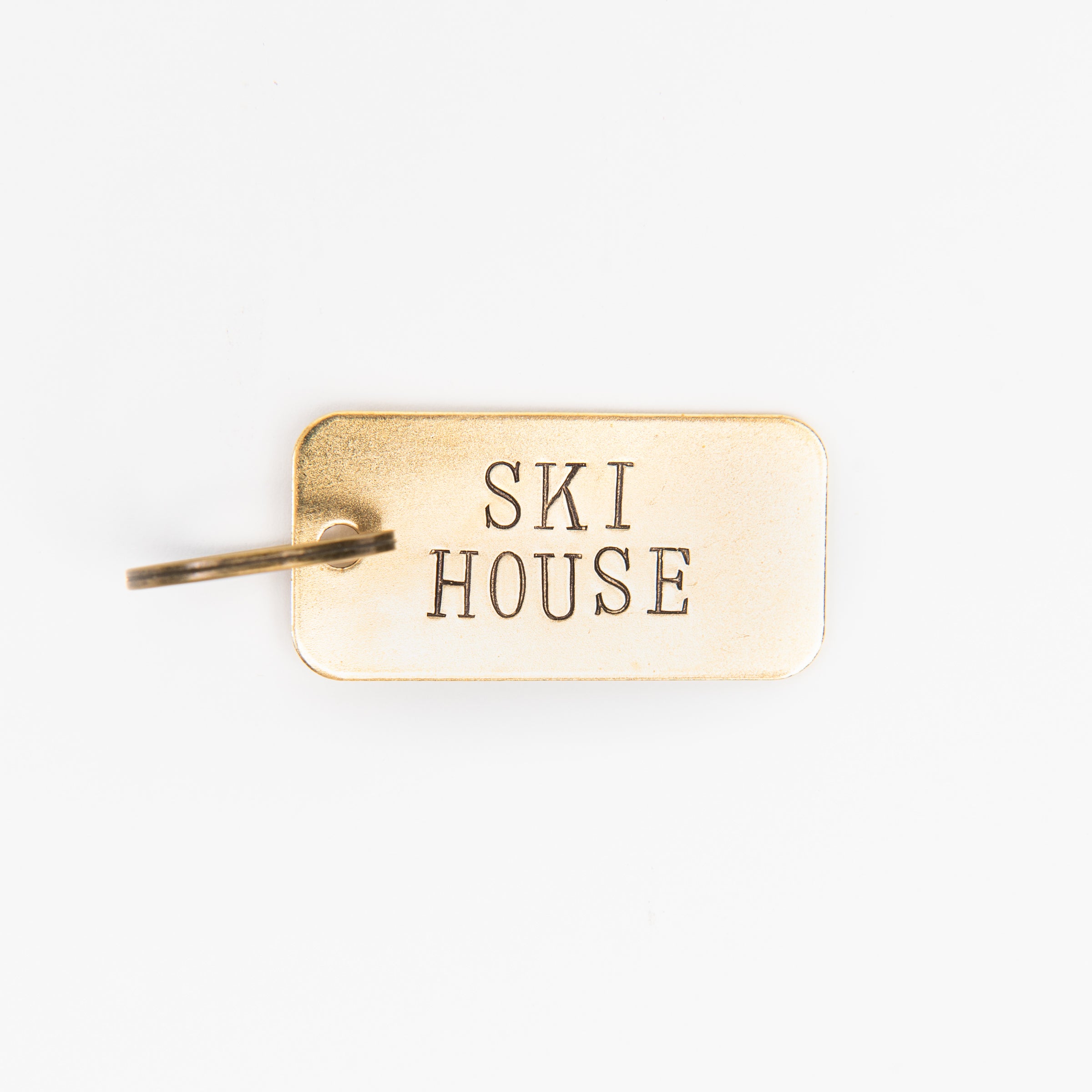 SKI HOUSE Rectangular Brass Key Ring on a white background at Addison West