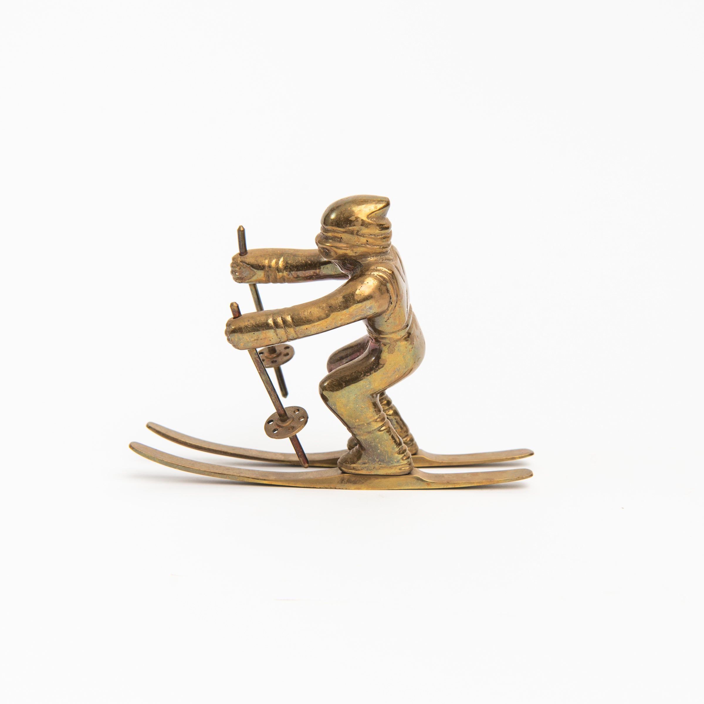 Vintage Brass Skier on a white background at Addison West