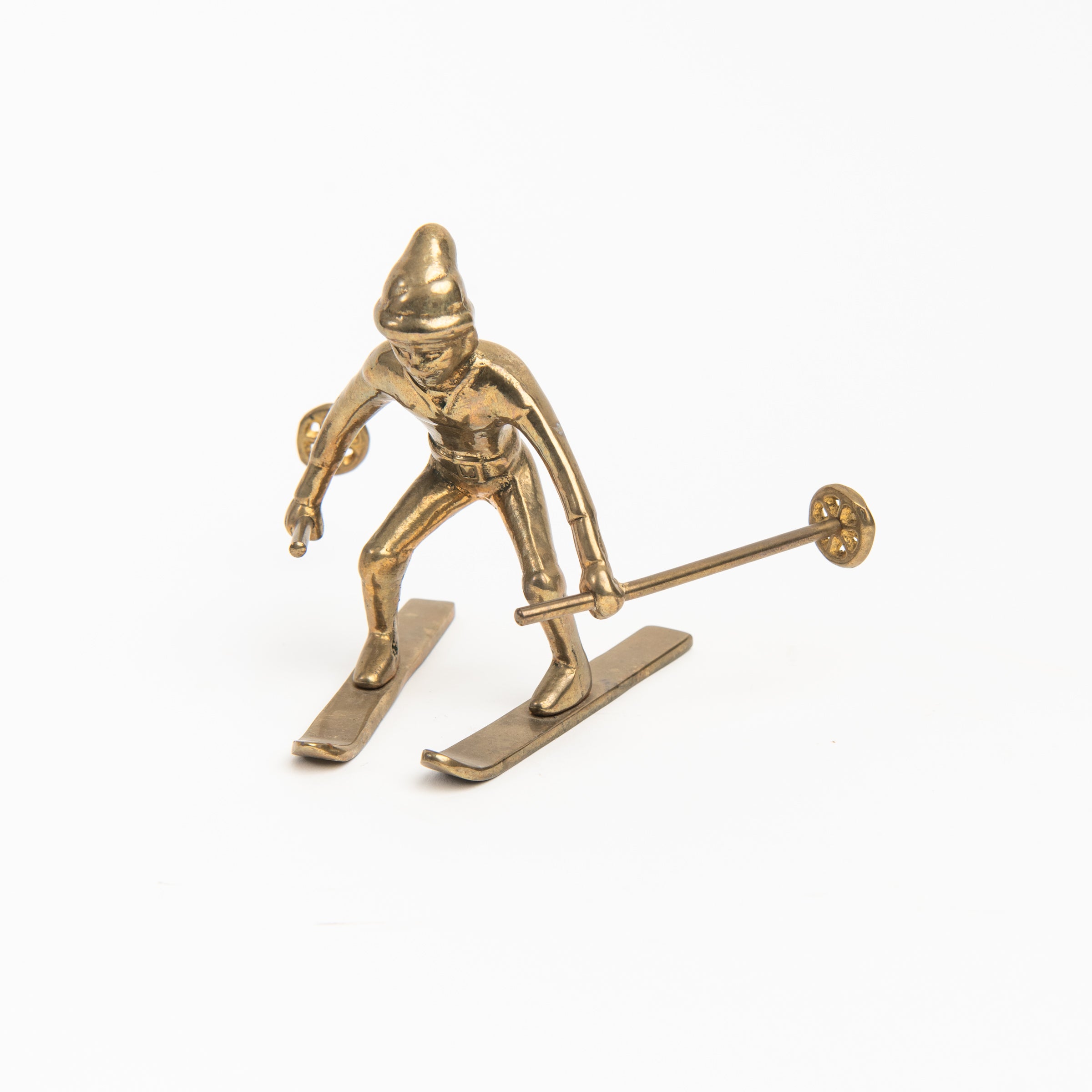Vintage Brass Snowplow Skier on a white background at Addison West