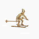 Vintage Brass Snowplow Skier on a white background at Addison West