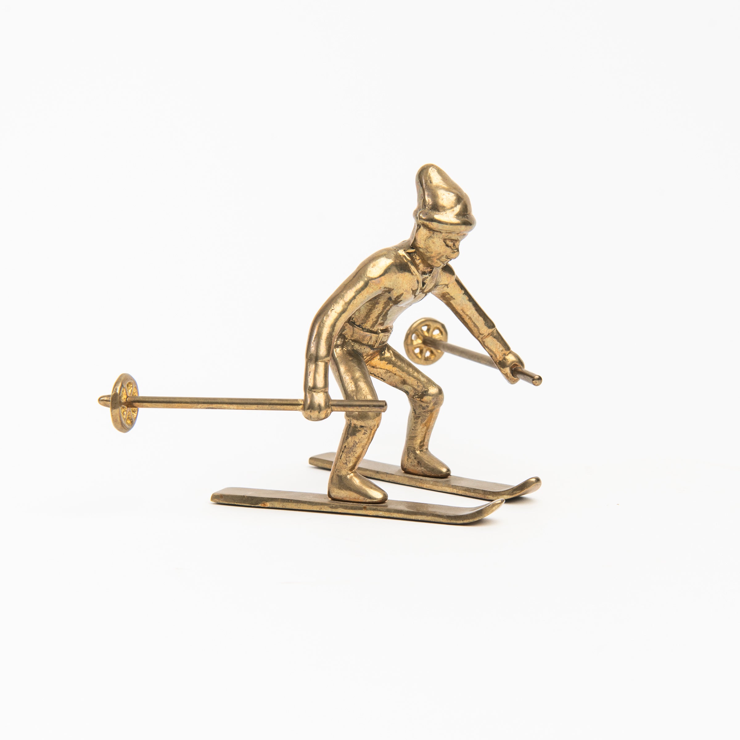 Vintage Brass Snowplow Skier on a white background at Addison West