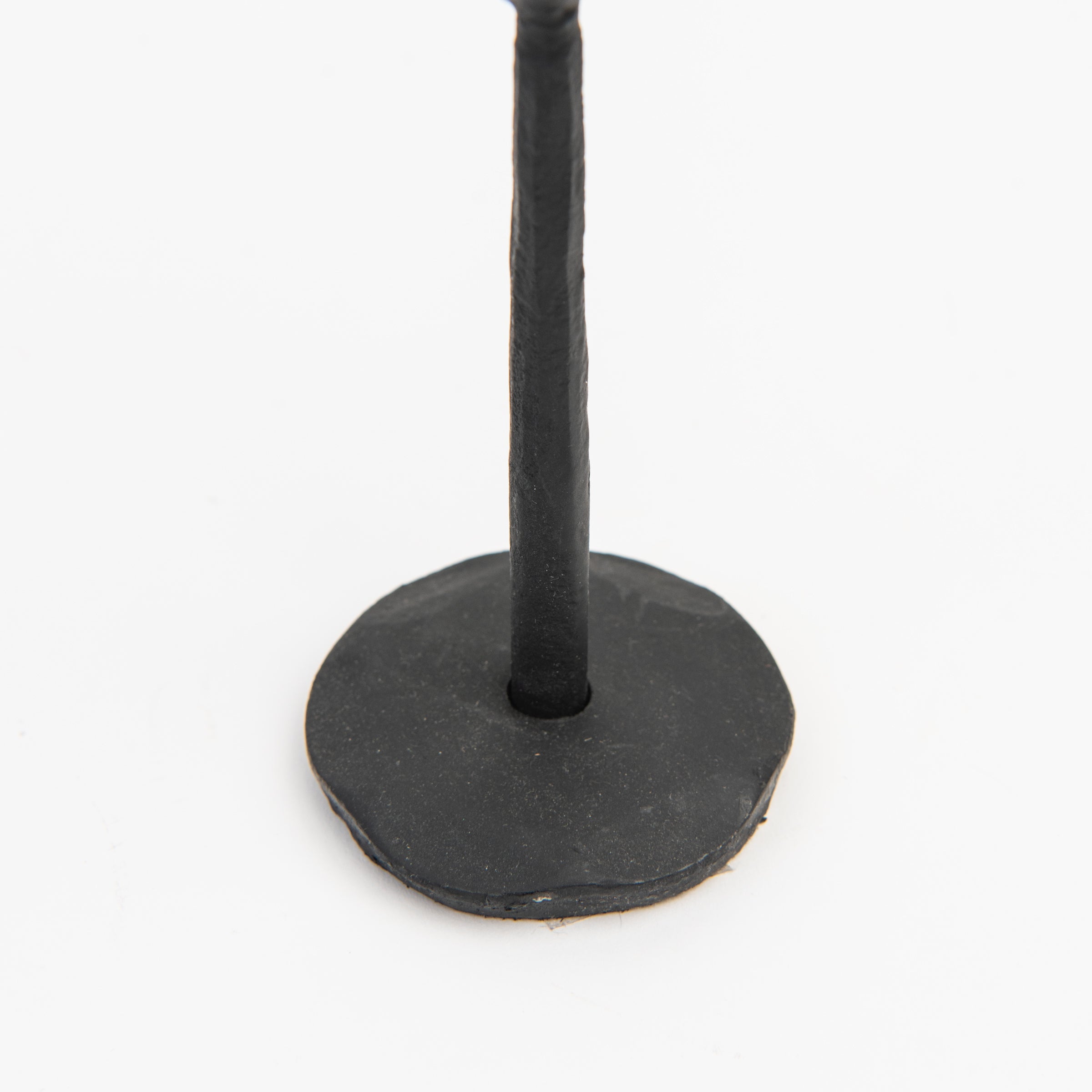 Close up of Legacy Forged Candlestick on a white background at Addison West