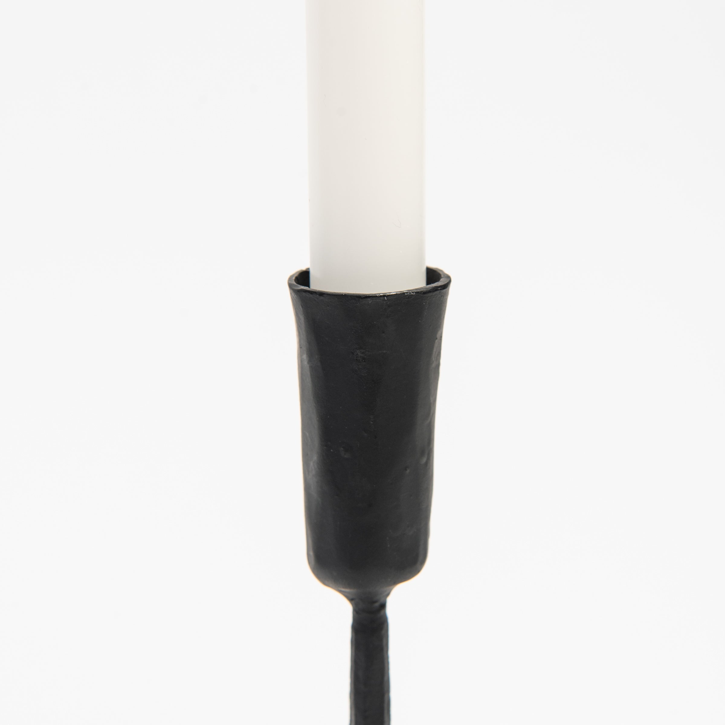 Close up of Legacy Forged Candlestick on a white background at Addison West