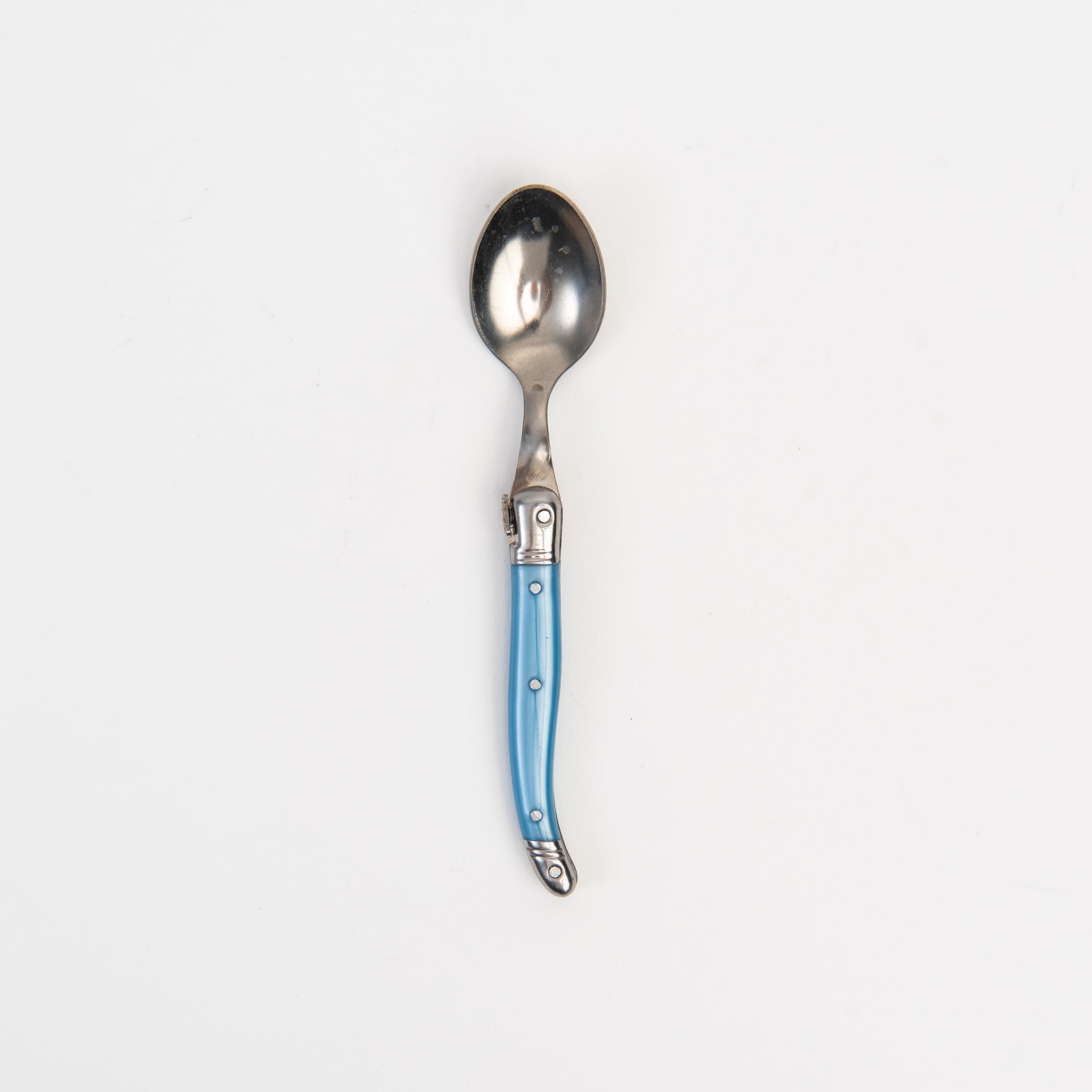 Laguiole Rainbow Spoon blue on a white background at Addison West