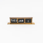 Vintage Brass Calendar on a white background at Addison West