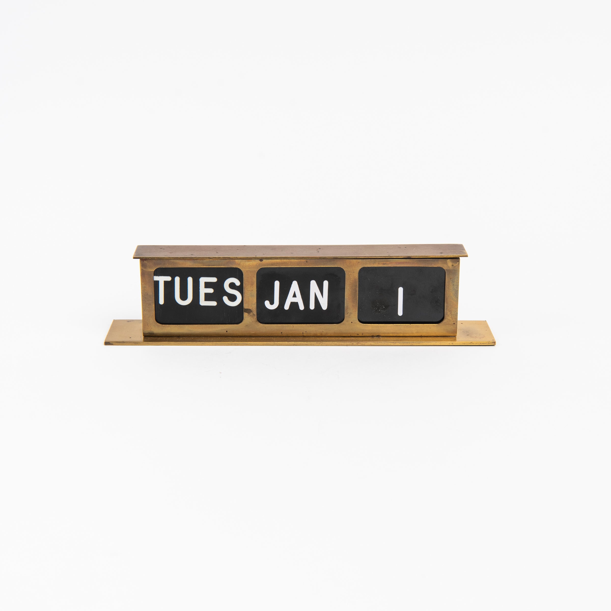 Vintage Brass Calendar on a white background at Addison West