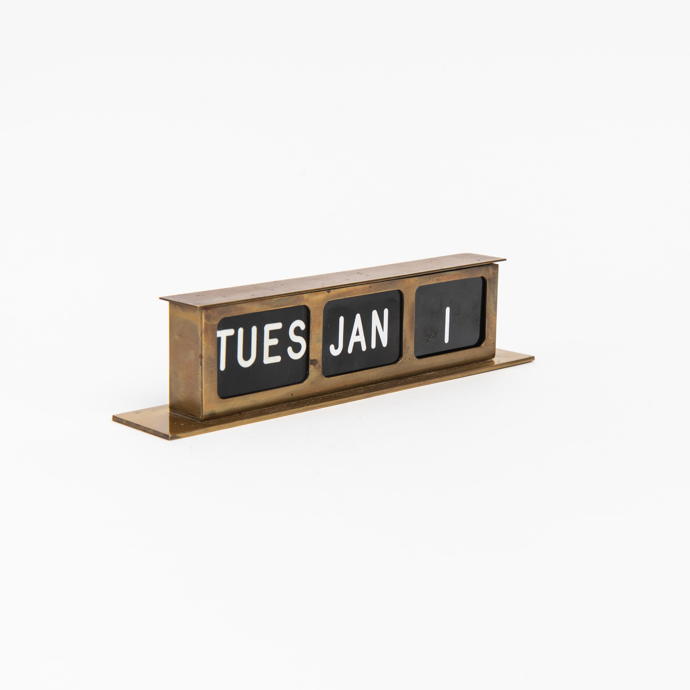 Vintage Brass Calendar on a white background at Addison West