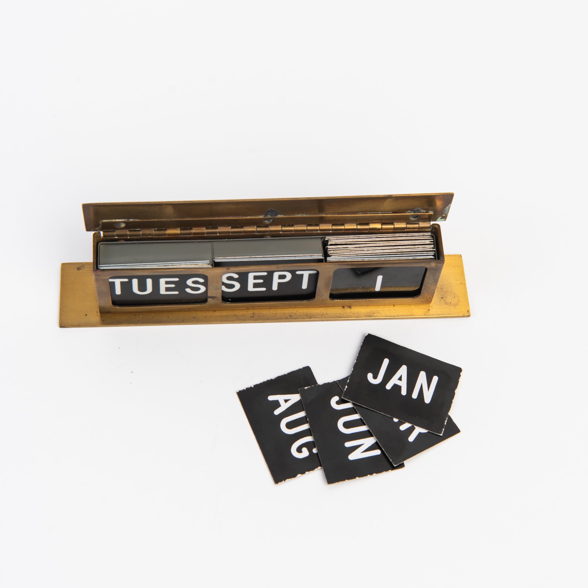 Vintage Brass Calendar on a white background at Addison West