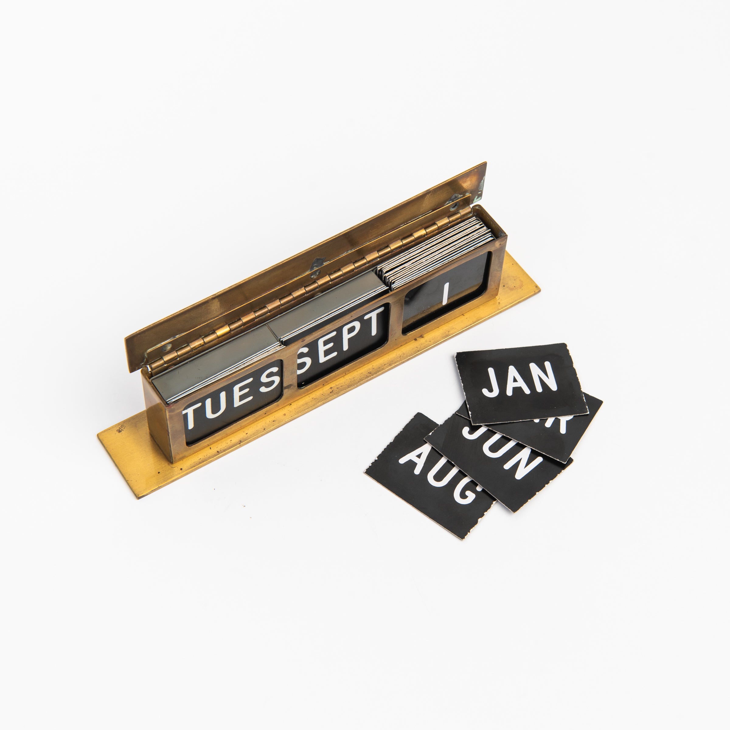 Vintage Brass Calendar on a white background at Addison West
