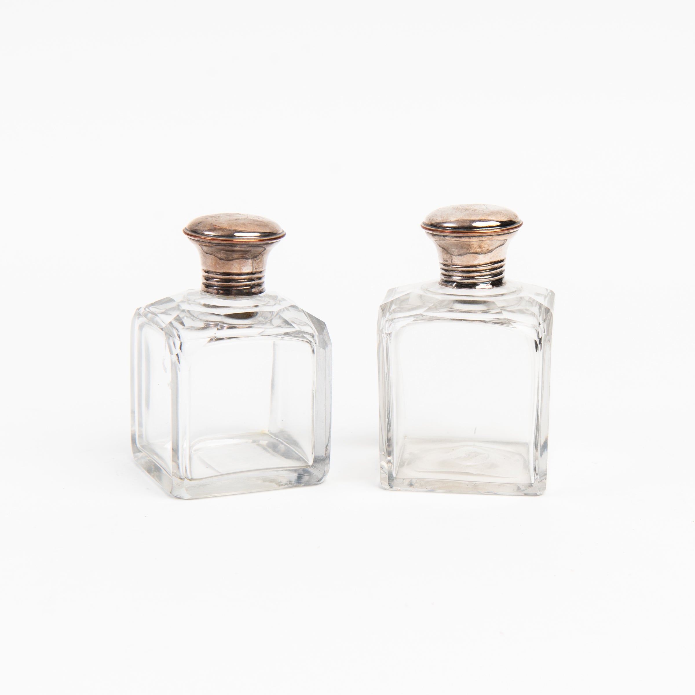 Vintage Glass Bottle With Silver Top on a white background at Addison West