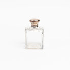 Vintage Glass Bottle With Silver Top on a white background at Addison West