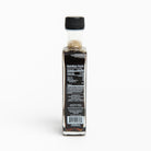 Side of Runamok Cinnamon & Vanilla Infused Maple Syrup on a table with food at Addison West