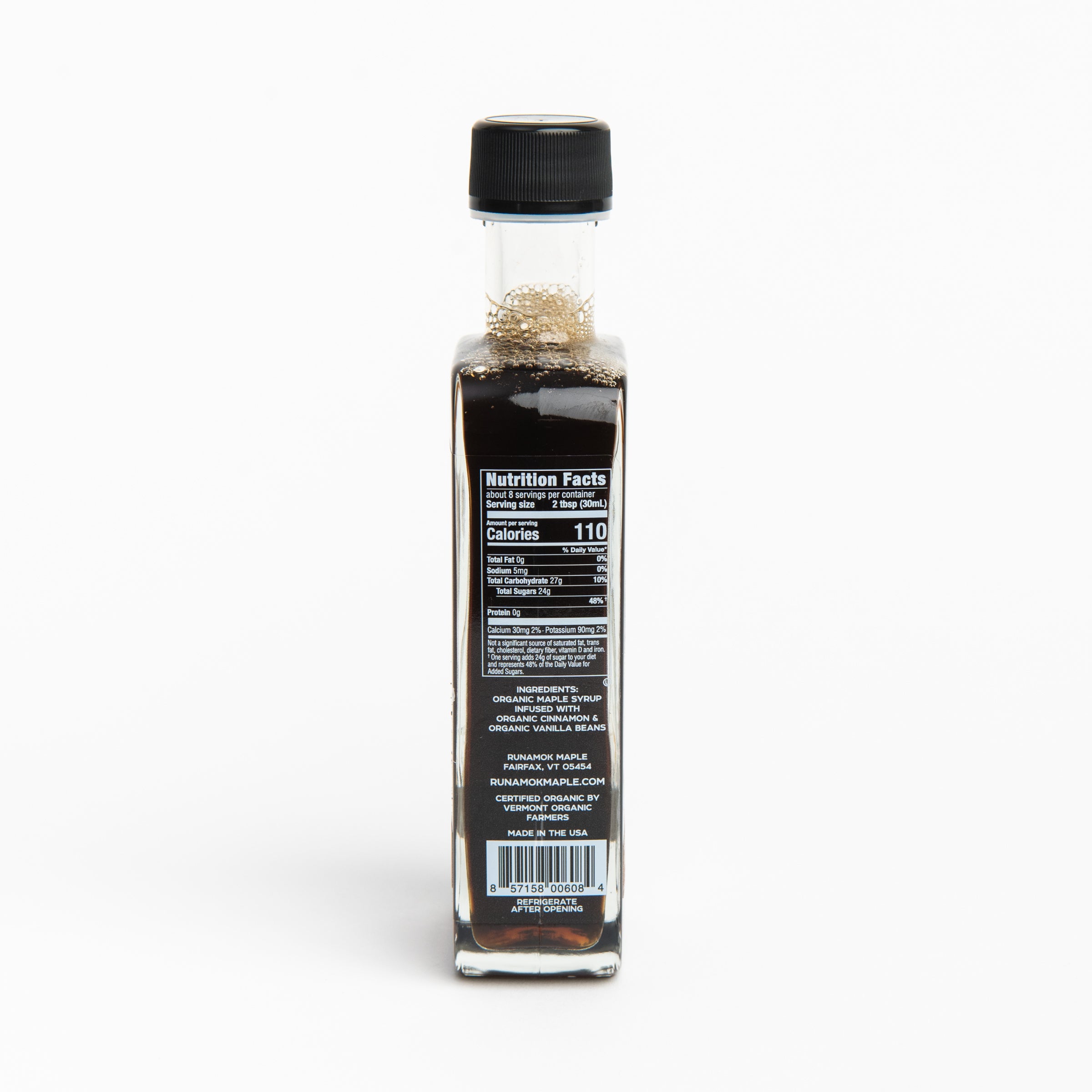 Side of Runamok Cinnamon & Vanilla Infused Maple Syrup on a table with food at Addison West