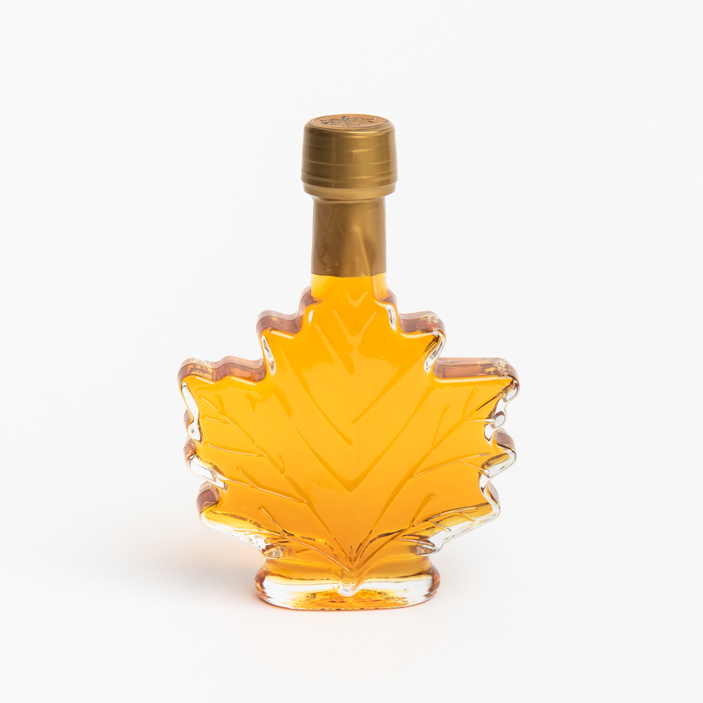 Mount Mansfield Maple Leaf Bottle Maple Syrup on a white background at Addison West