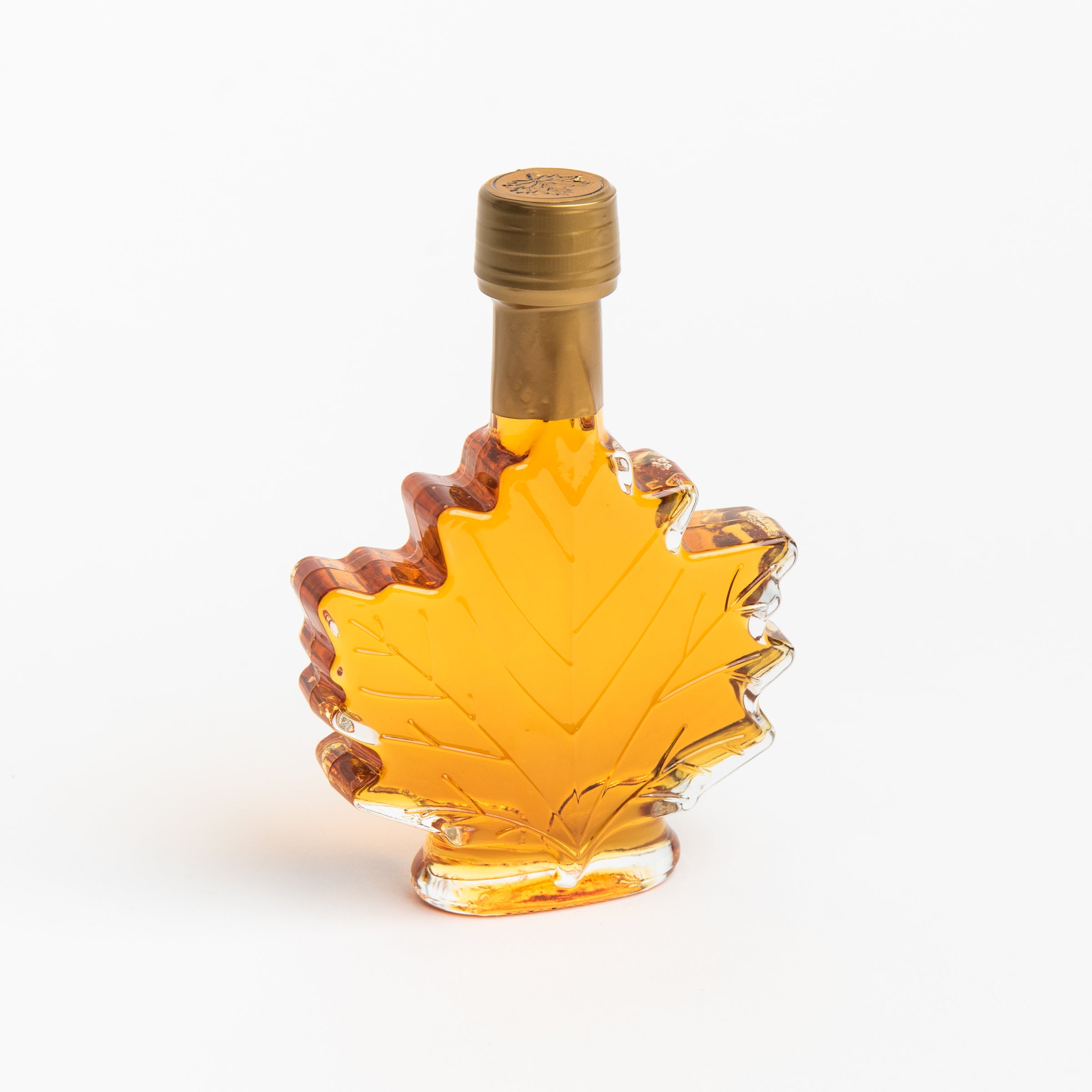Mount Mansfield Maple Leaf Bottle Maple Syrup on a white background at Addison West