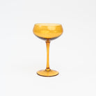 Cheers to You Glass in Amber on a white background at Addison West