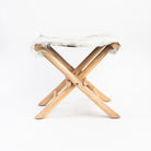 Teakwood and Goat Fur Folding Stool on a white background at Addison West