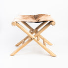 Teakwood and Goat Fur Folding Stool on a white background at Addison West
