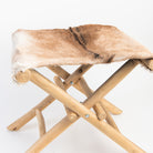 Teakwood and Goat Fur Folding Stool on a white background at Addison West