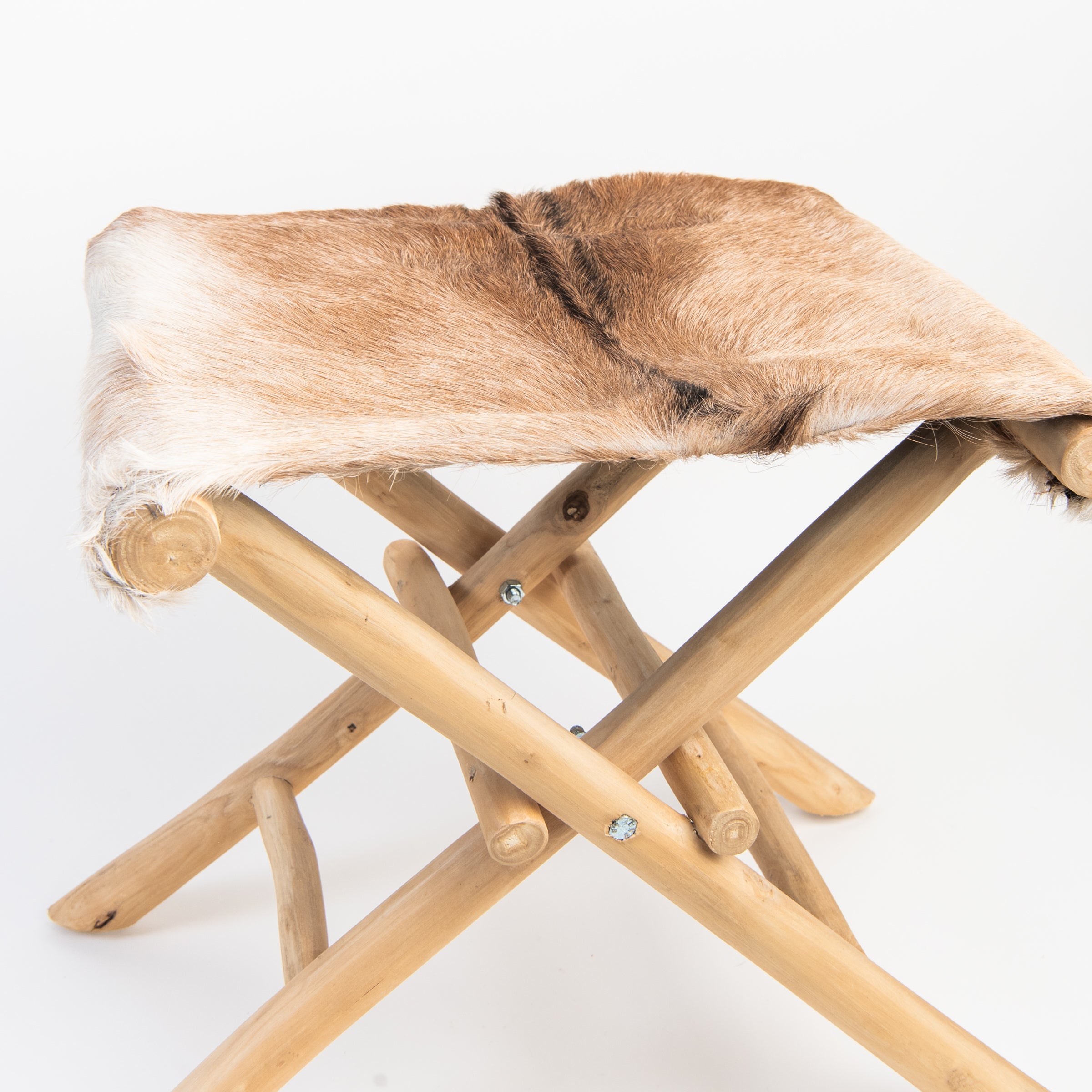 Teakwood and Goat Fur Folding Stool on a white background at Addison West