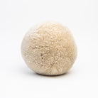 Sheepskin Ball Throw Pillow on a white background at Addison West