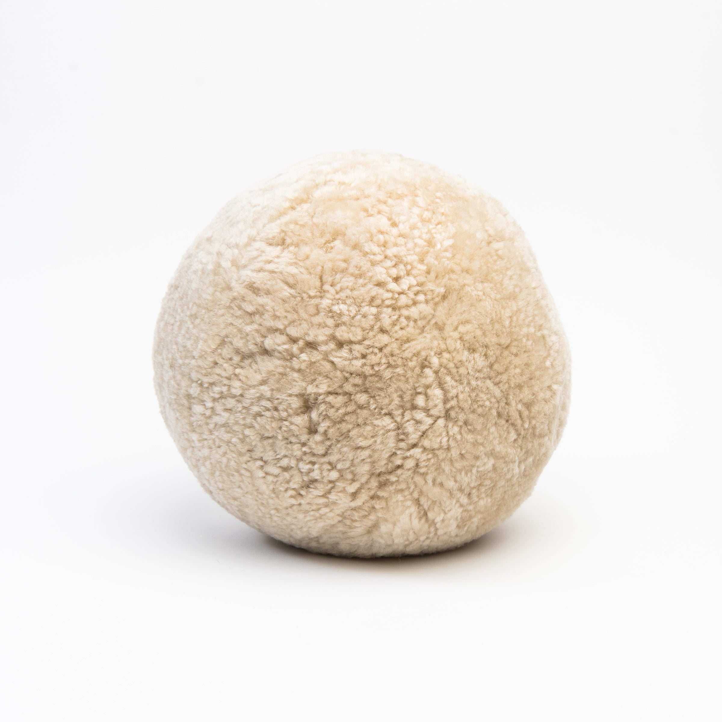Sheepskin Ball Throw Pillow on a white background at Addison West