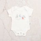 Mountain Baby Organic Cotton Babysuit on a marble table at Addison West