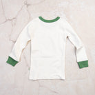 Apres Ski Organic Cotton Toddler PJs on a marble table at Addison West