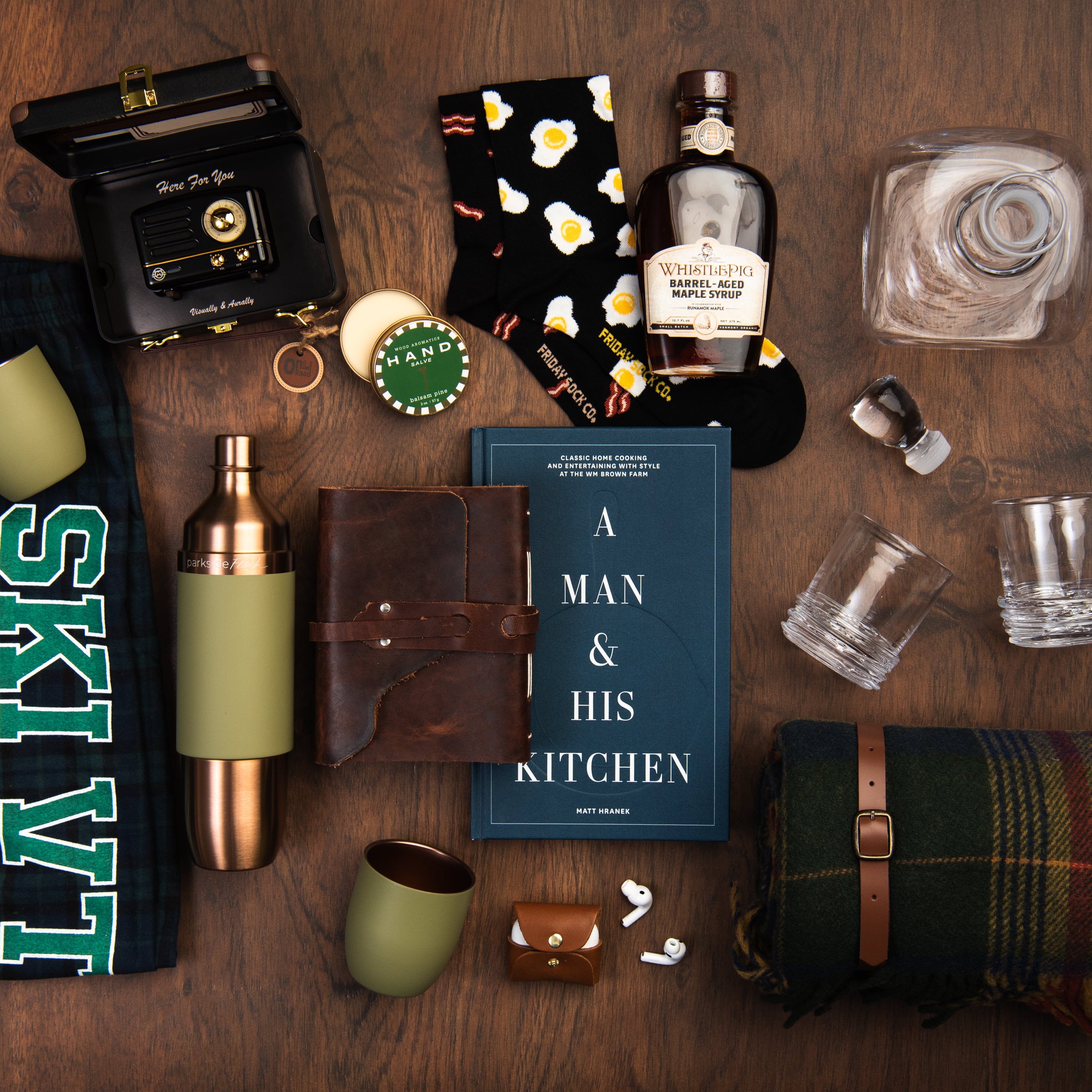 Collection of gifts for him items on a wood table at Addison West