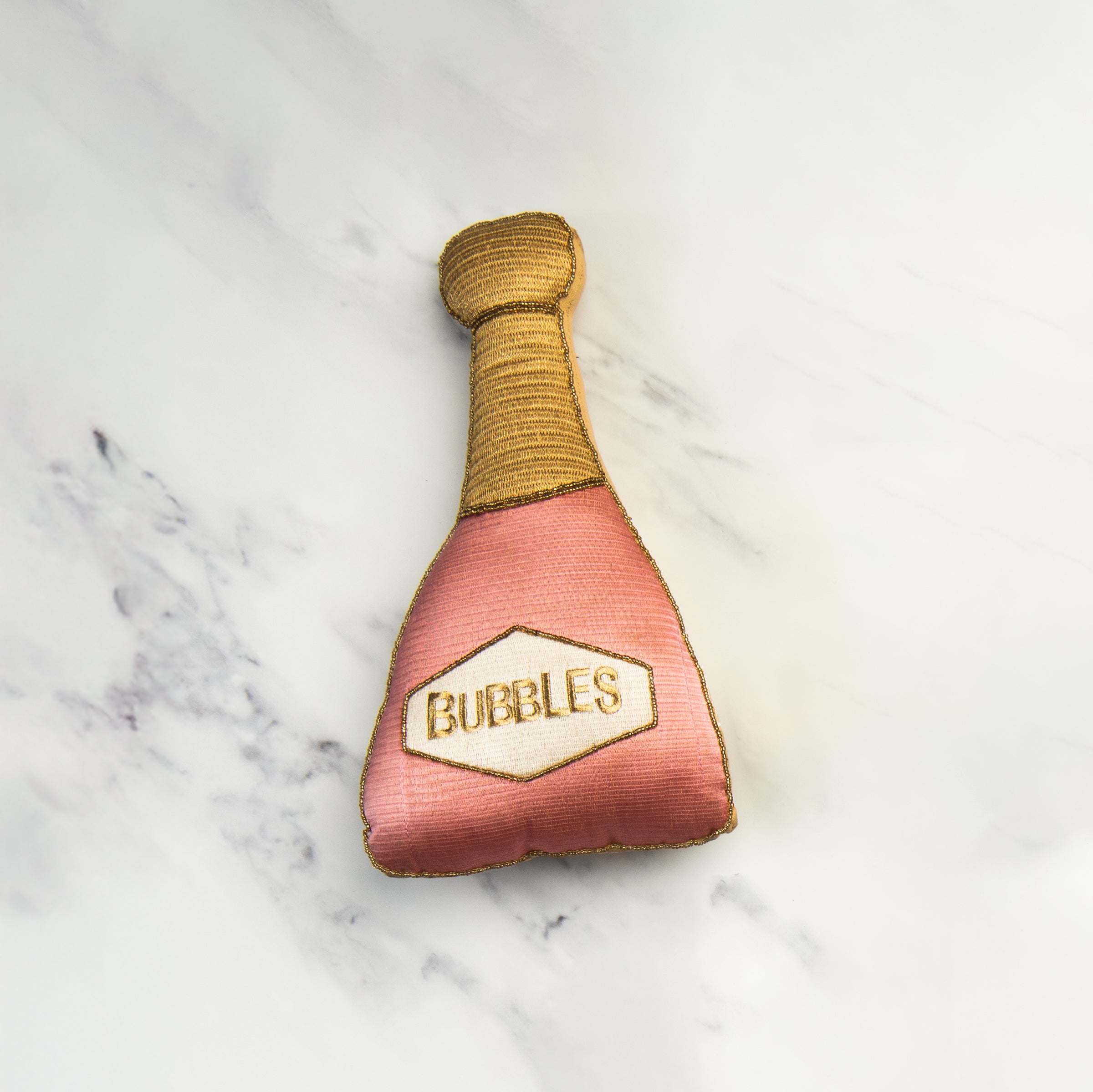 Champagne Bubbles Throw Pillow on a marble table at Addison West